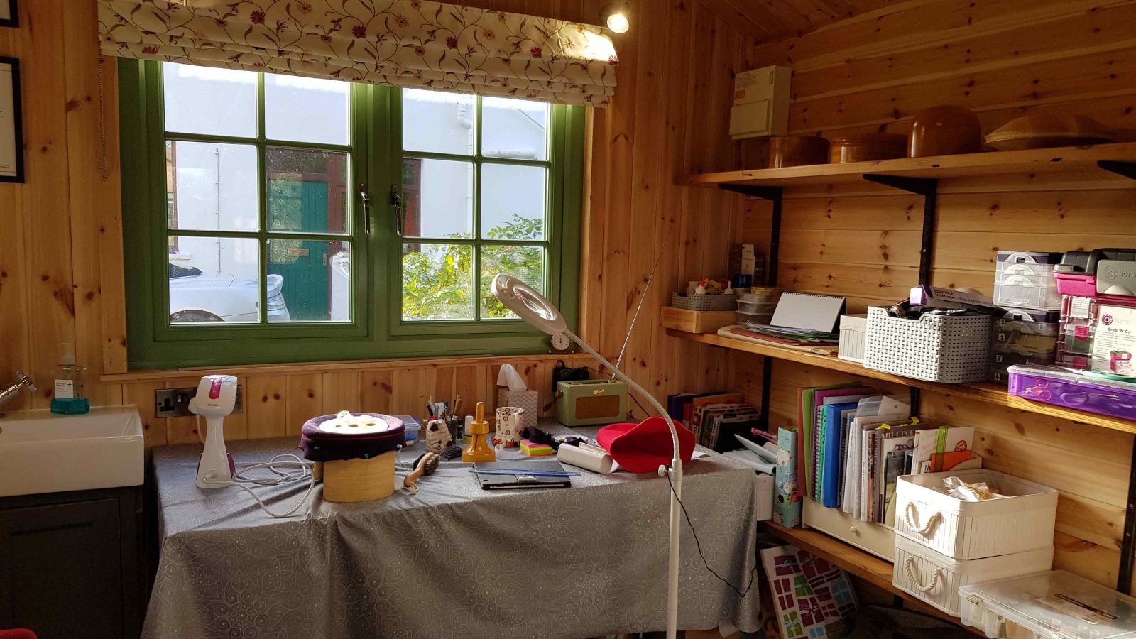 Inside view of Glen Moar Millinery studio showing Susan's work table and hat blocks